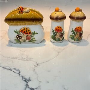 Merry Mushroom Napkin holder and salt and pepper spice shakers.